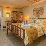 ROOM-03-01-150x150 ROOM-03-01-150x150 King bed with floral bedding, mustard throw, and wall-mounted air conditioning in Panpurie Garden Terrace room Accommodations ROOM 03 01 150x150